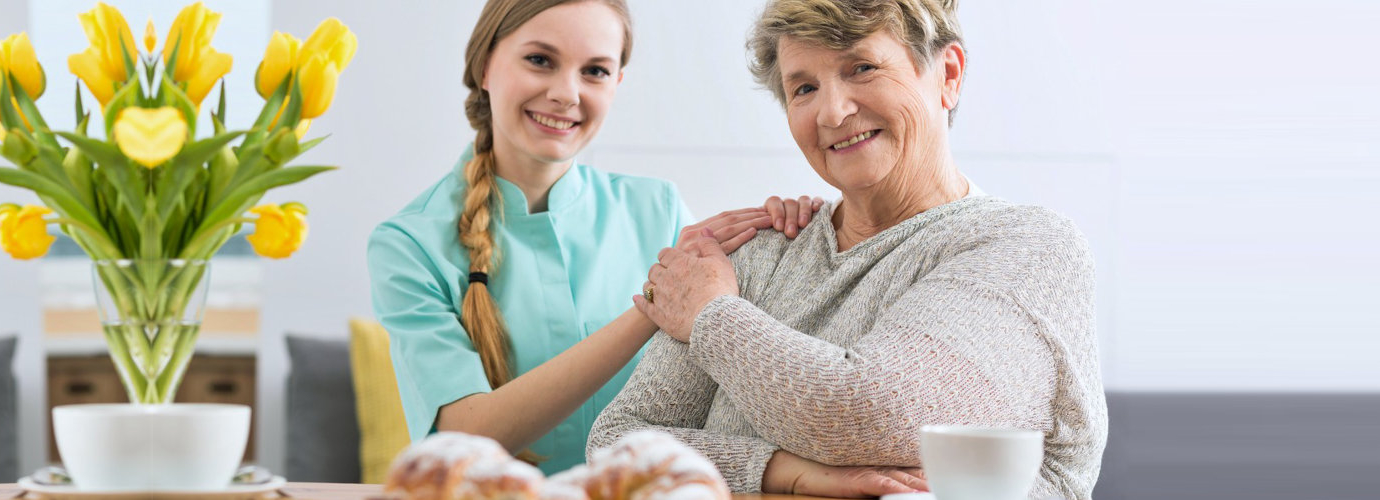 senior woman holding caregivers hand